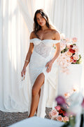 Side view showing the drape of the white off-shoulder lace maxi dress