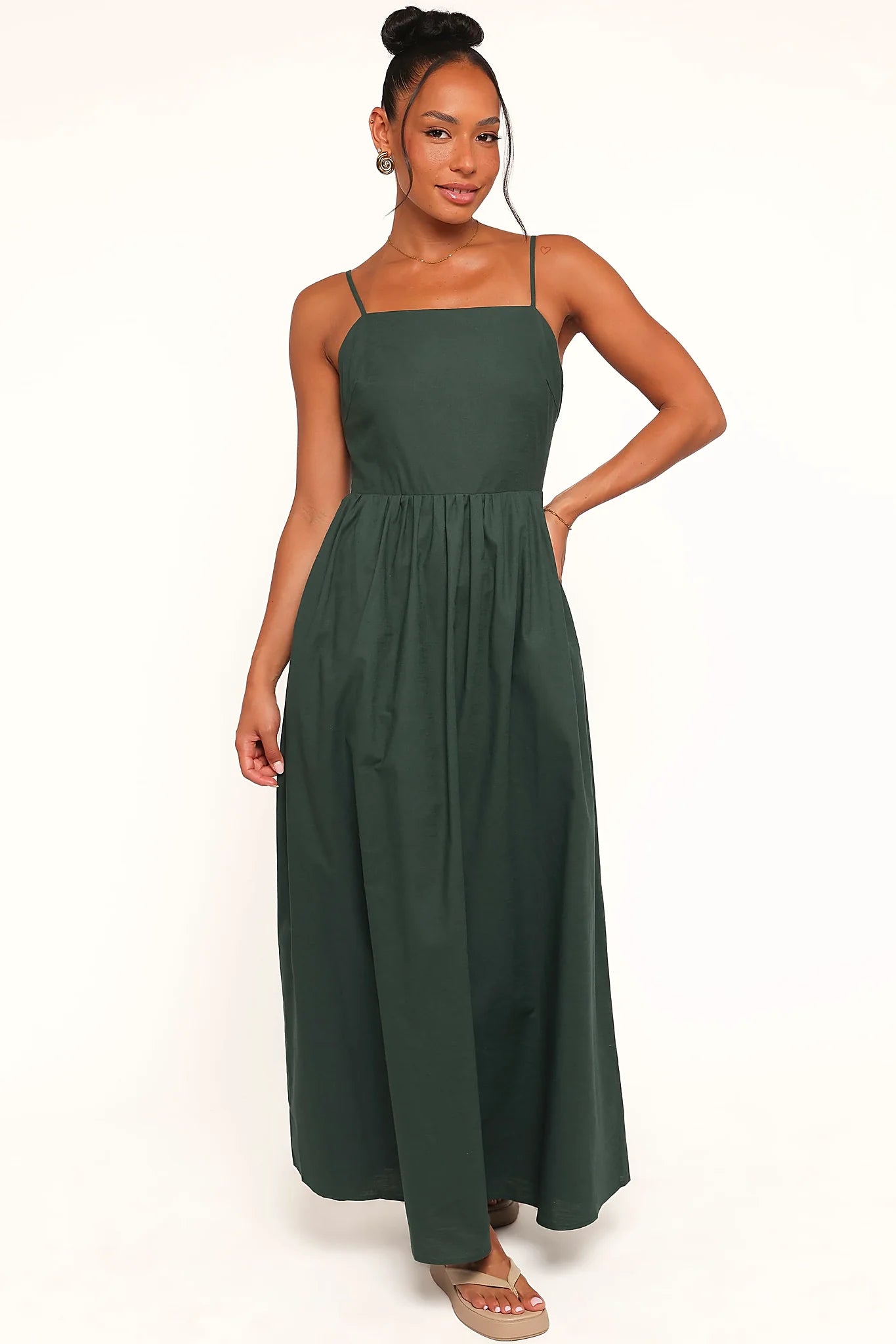 Close-up of the neckline of the forest green maxi dress