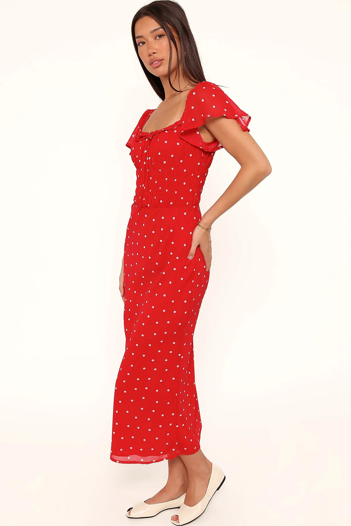 Model wearing the red polka dot maxi dress, front view