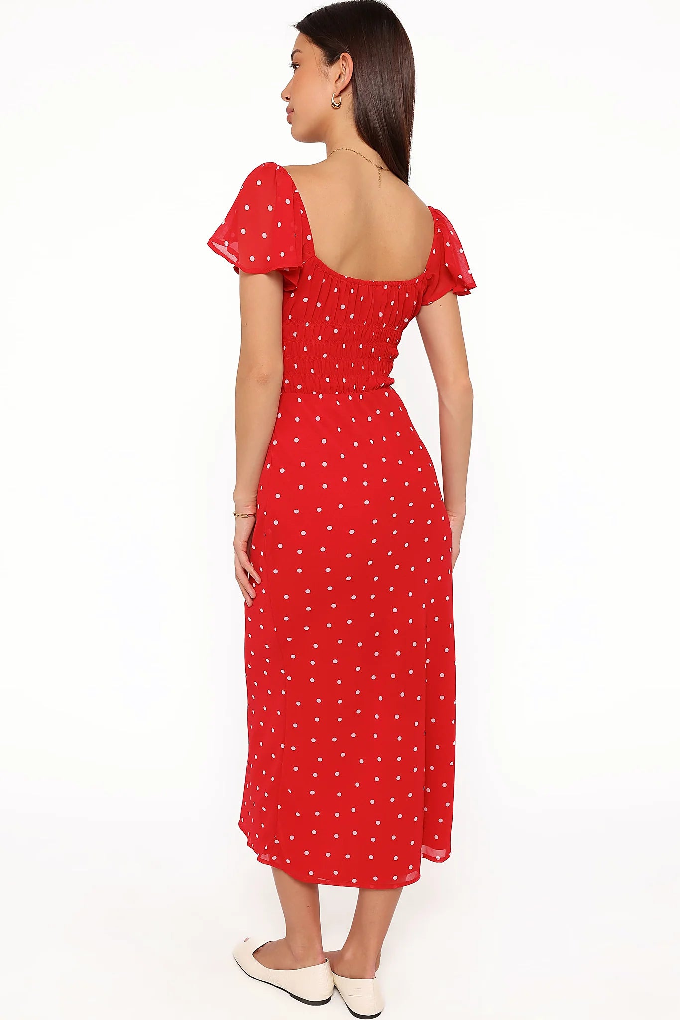 Back view of the red polka dot maxi dress on a model