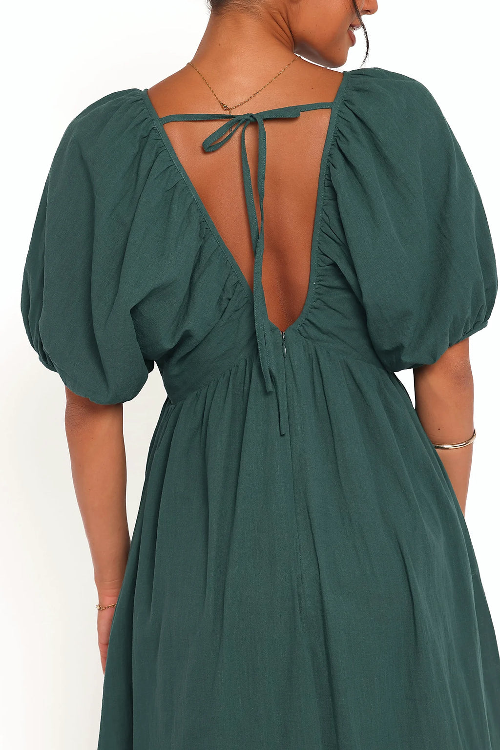 Back view of the forest green puff-sleeve maxi dress on a model
