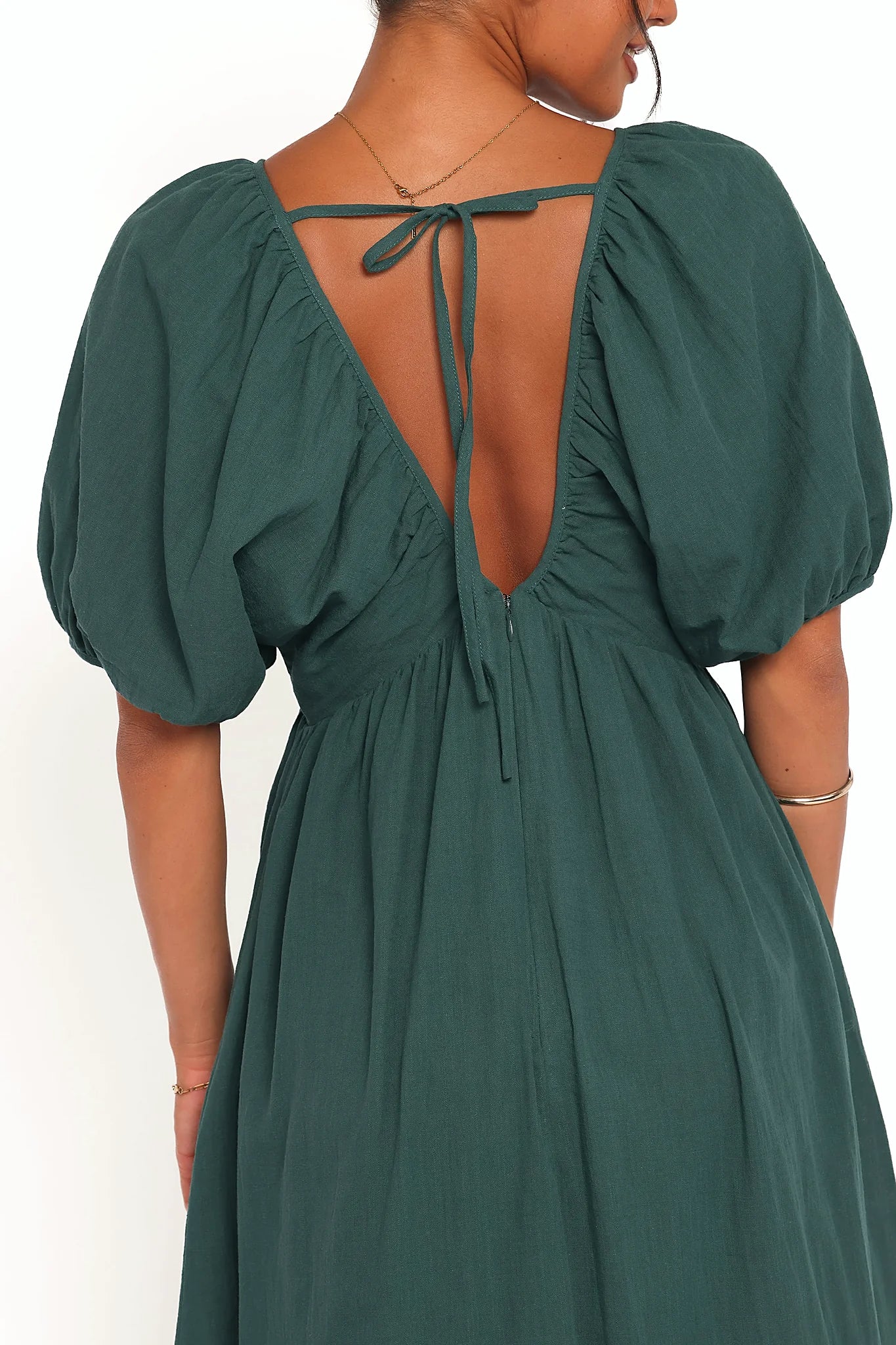 Back view of the forest green puff-sleeve maxi dress on a model