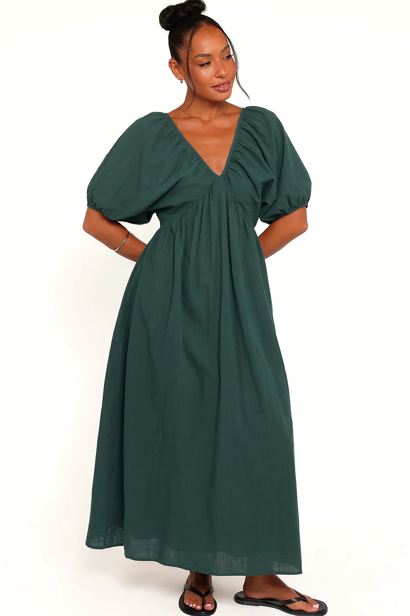 Model wearing the forest green puff-sleeve maxi dress, front view
