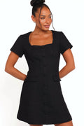 Model wearing the black tweed mini dress, front view