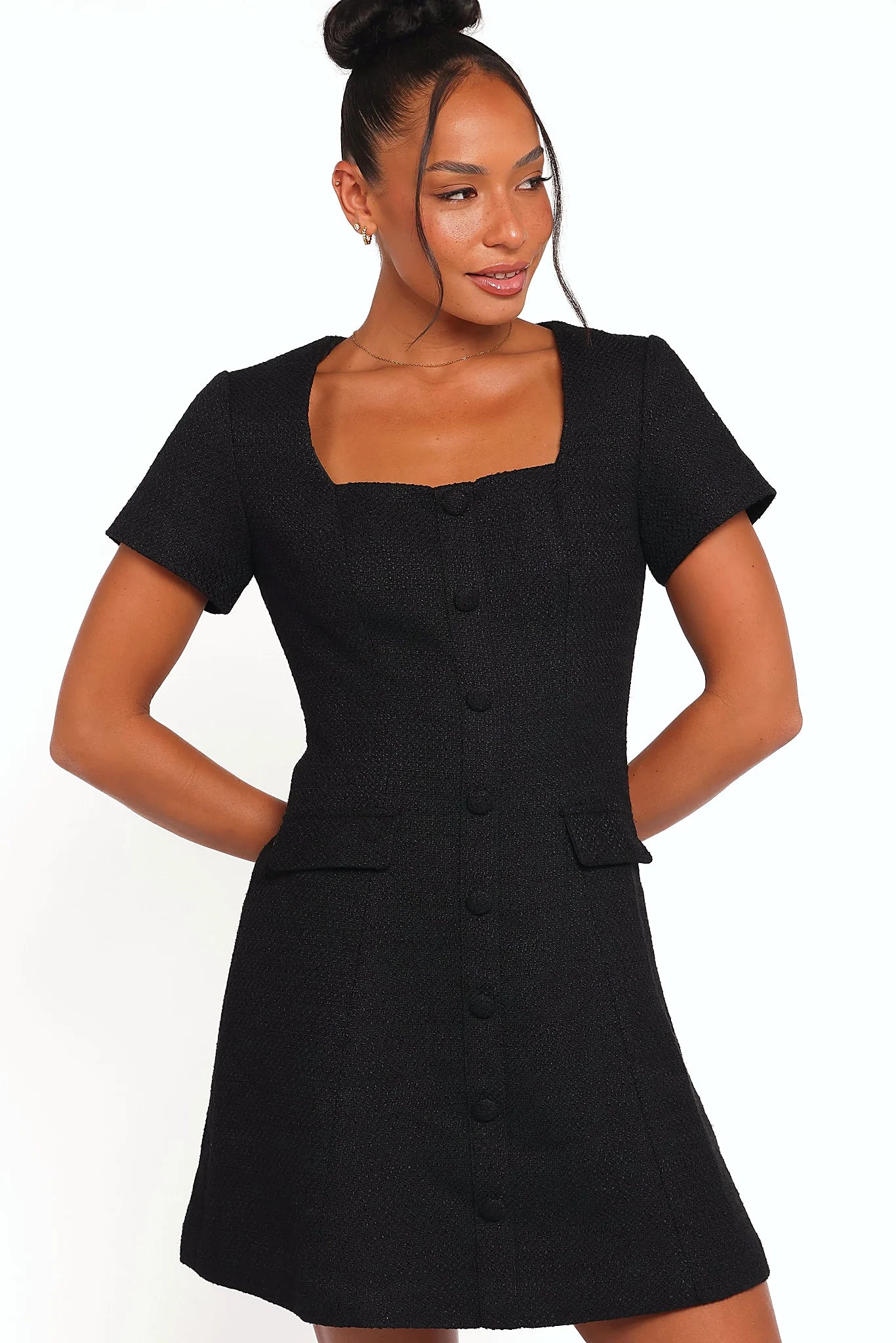 Model wearing the black tweed mini dress, front view