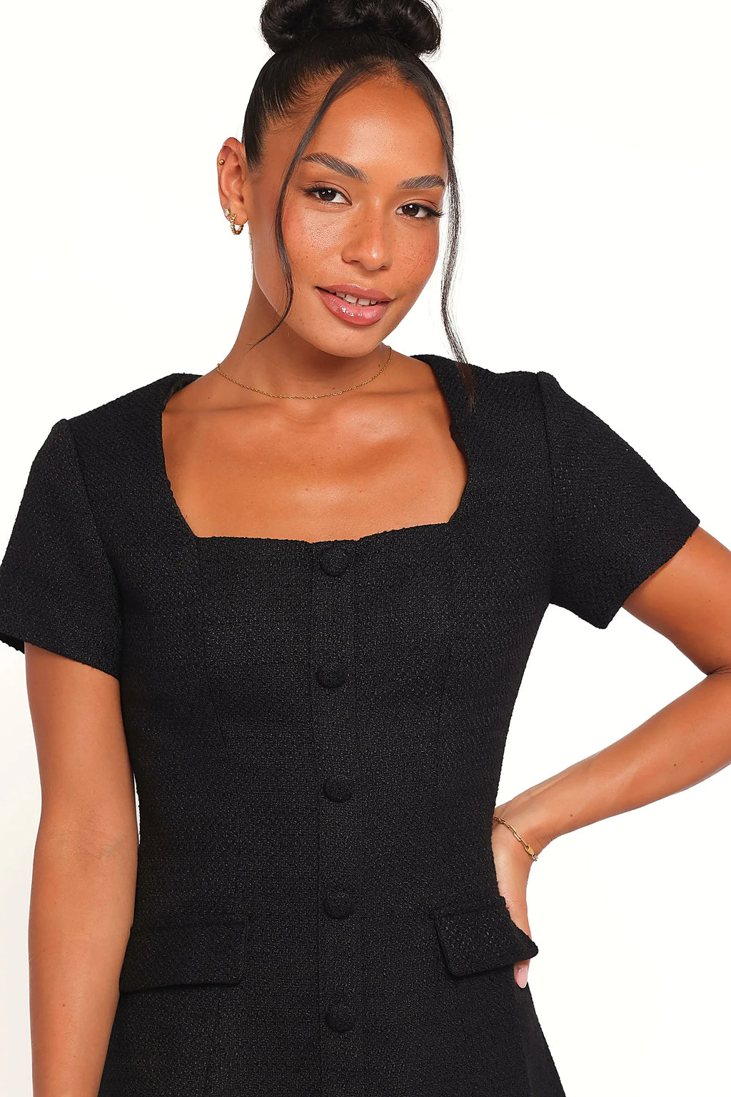 Back view of the black tweed mini dress on a model