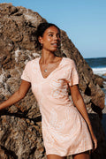 Close-up of the neckline of the peach floral mini dress