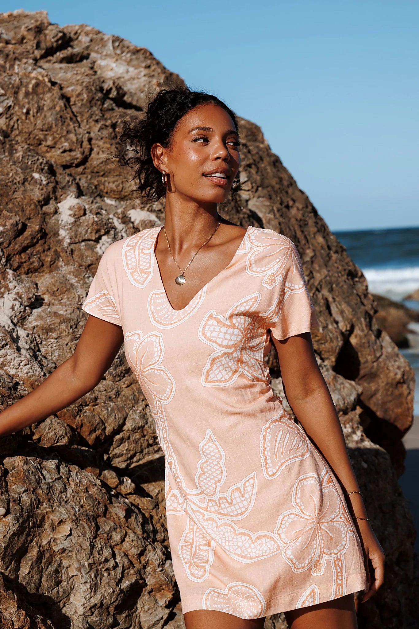 Close-up of the neckline of the peach floral mini dress