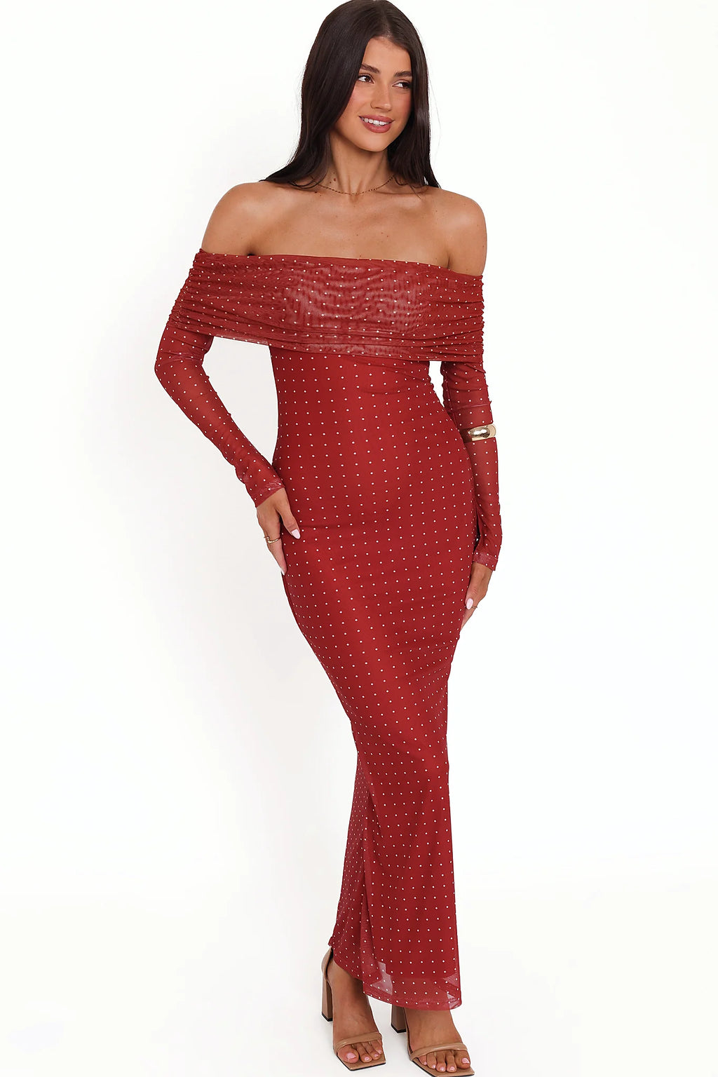 Side view showing the drape of the burgundy spot off-shoulder maxi dress