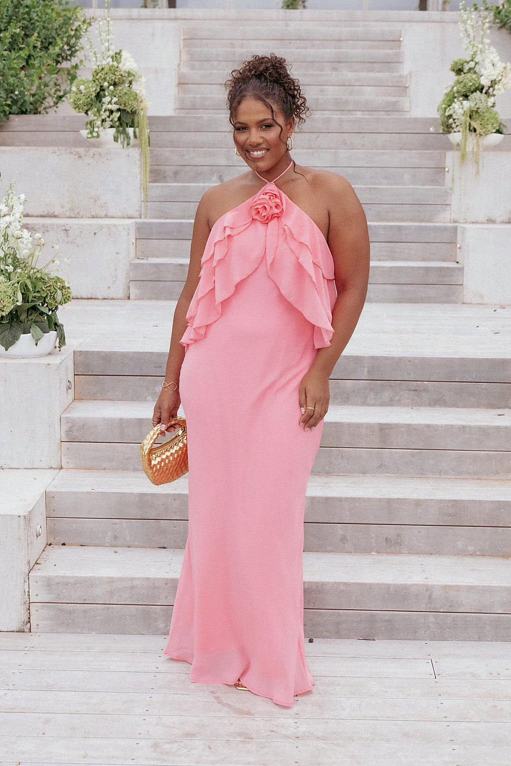 Detail view of the coral halterneck maxi dress